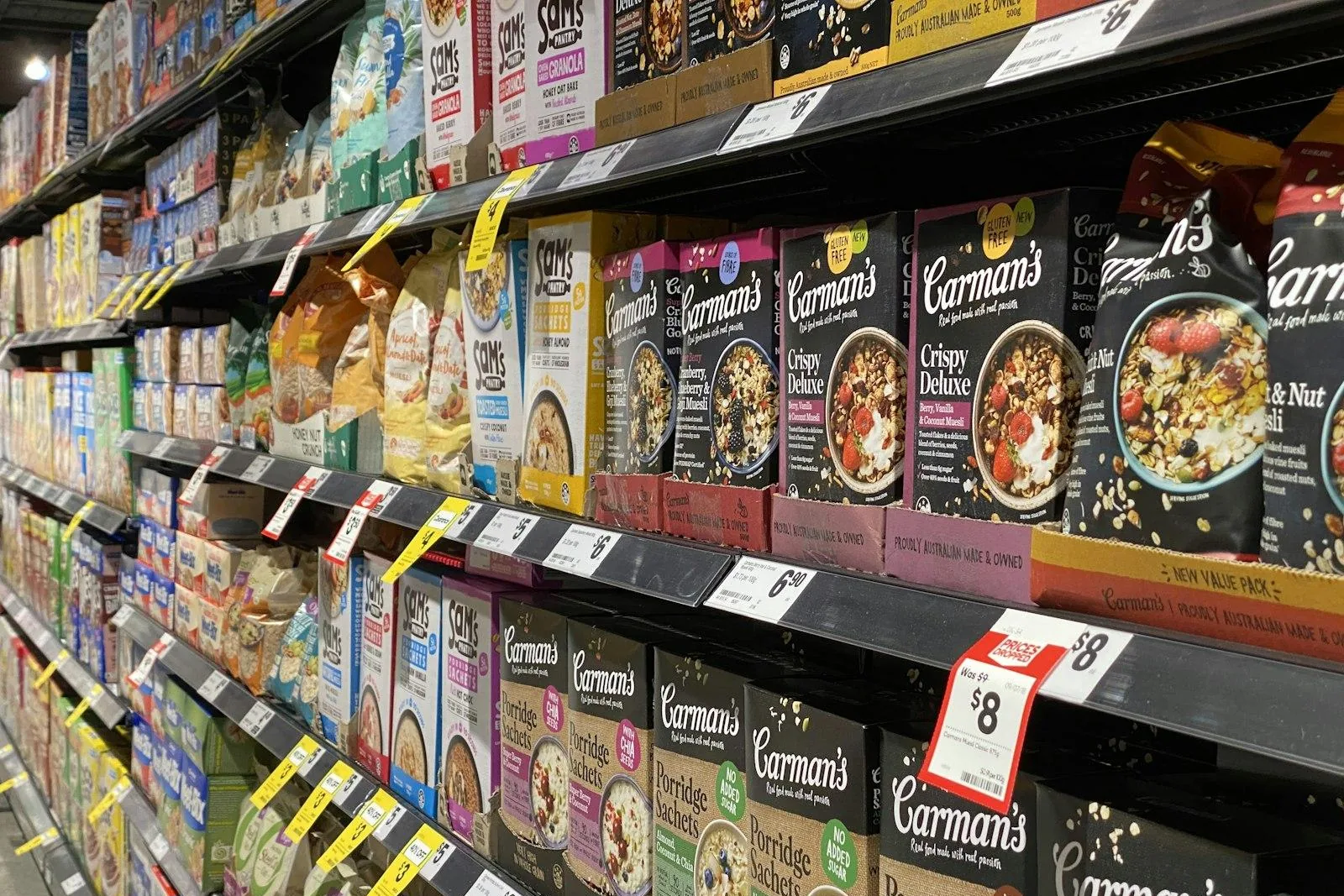 Supermarket shelves stocked with boxed cereals and snacks
